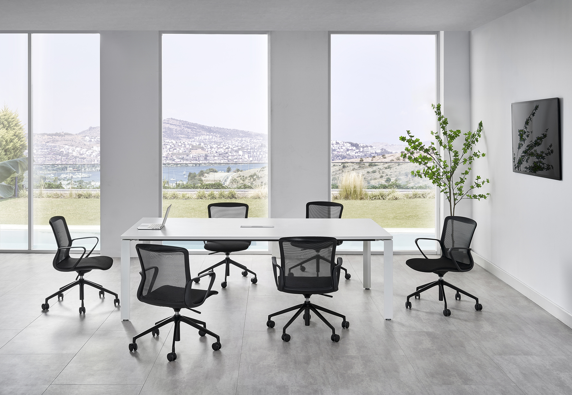 Mesh-back office chairs around conference table